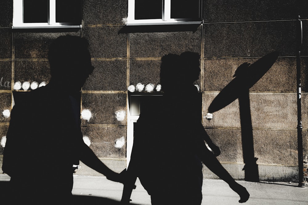 silhouette of three person walking