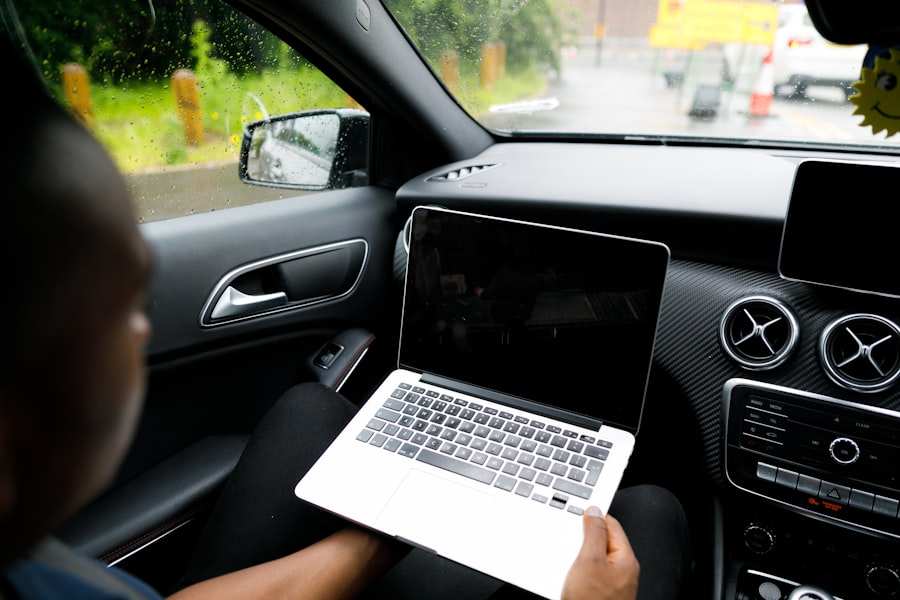 Technician reviewing a laptop-based ECU tune on a running car