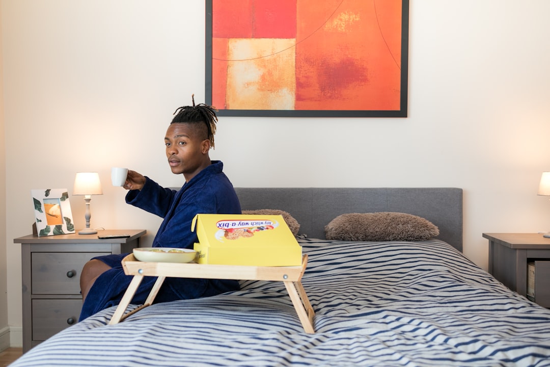 man sits on bed,