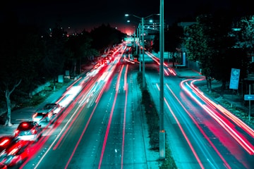 time-lapse photography of vehicles on road at night