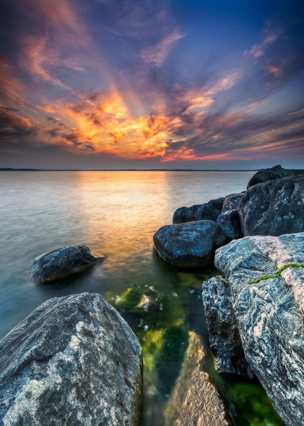 rock formations beside body of water at golden hour