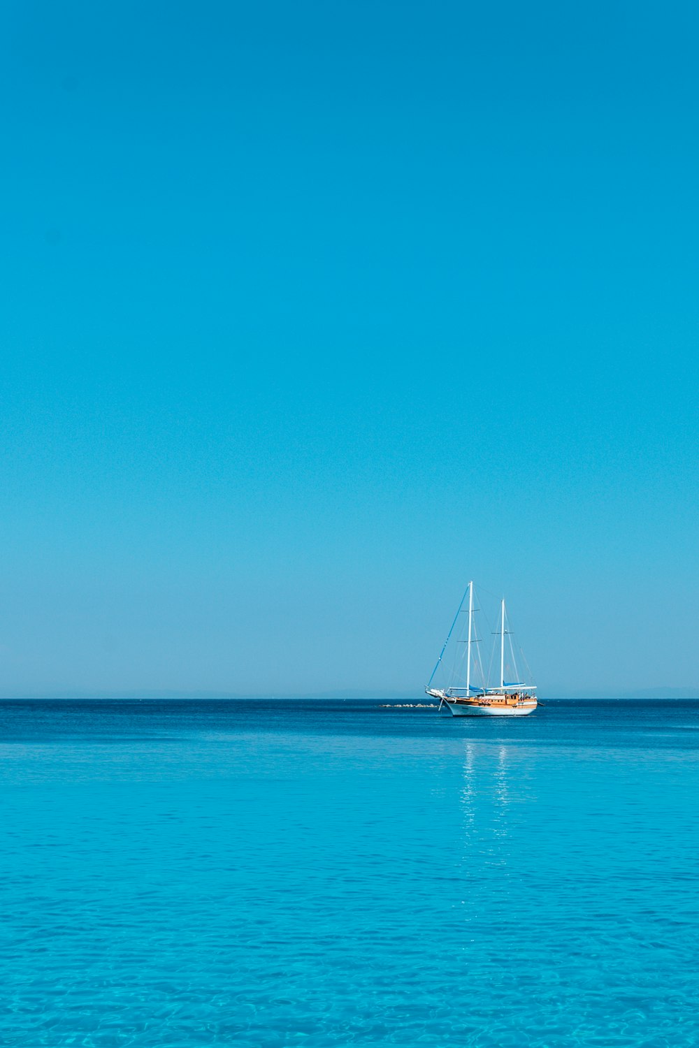 white and brown boat on body of water at daytime