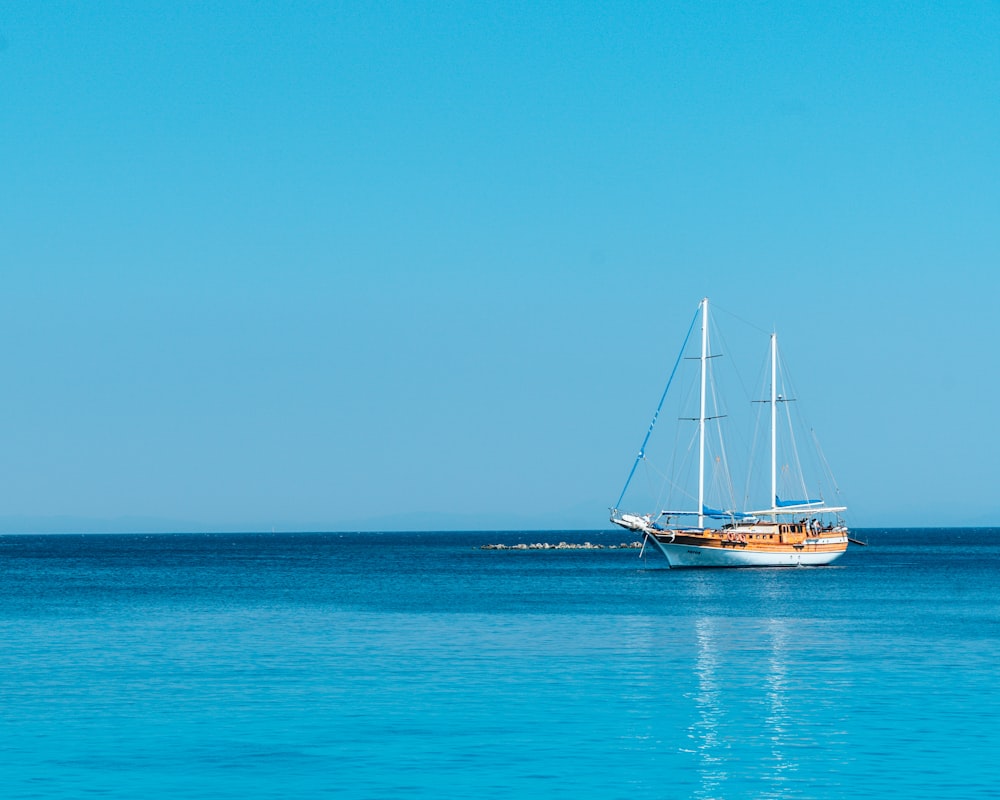 barca sullo specchio d'acqua sotto il cielo blu durante il giorno