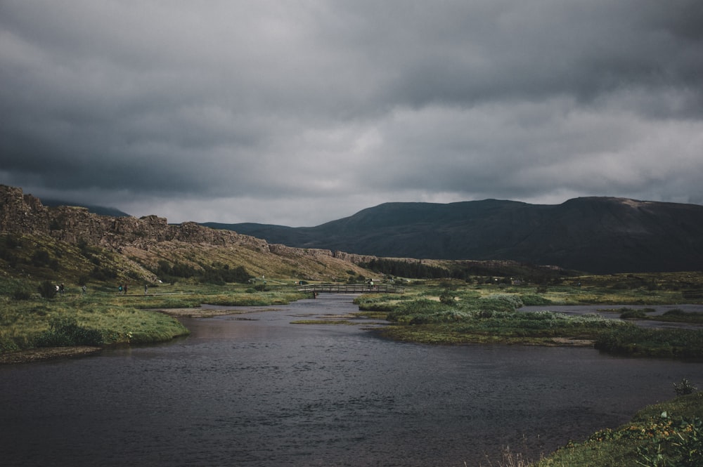 body of water near mountains