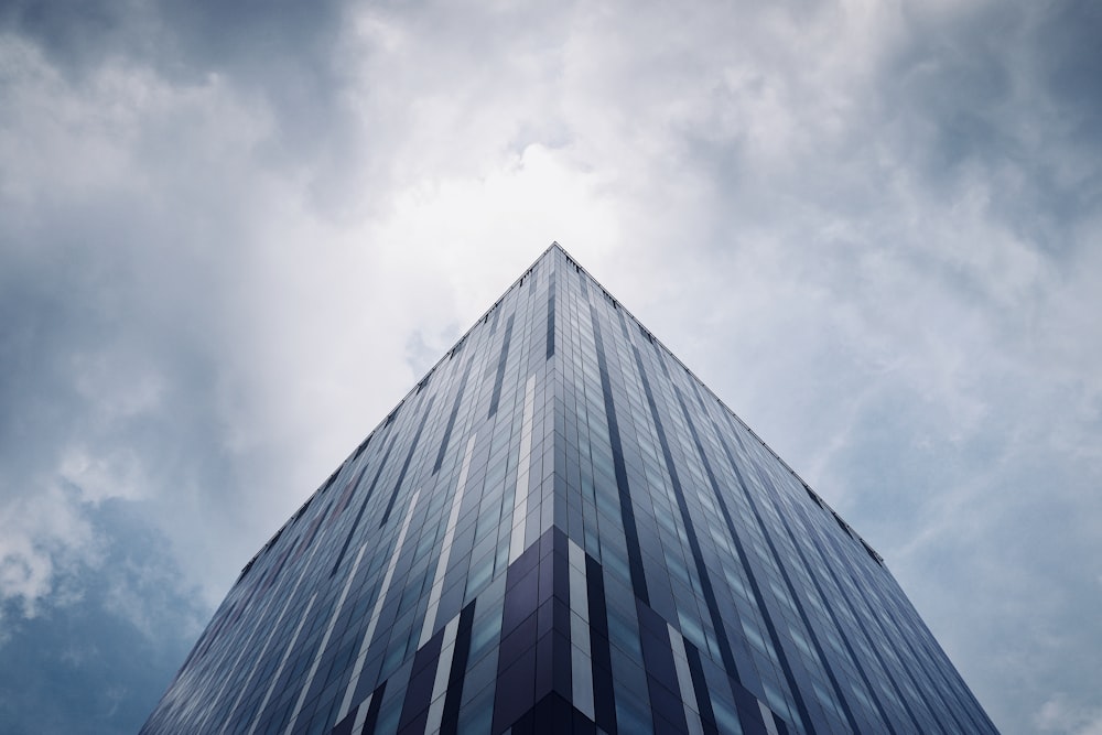 low-angle photo of building under cloudy sky