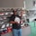 A happy customer trying on a pair of shoes in a bright store.