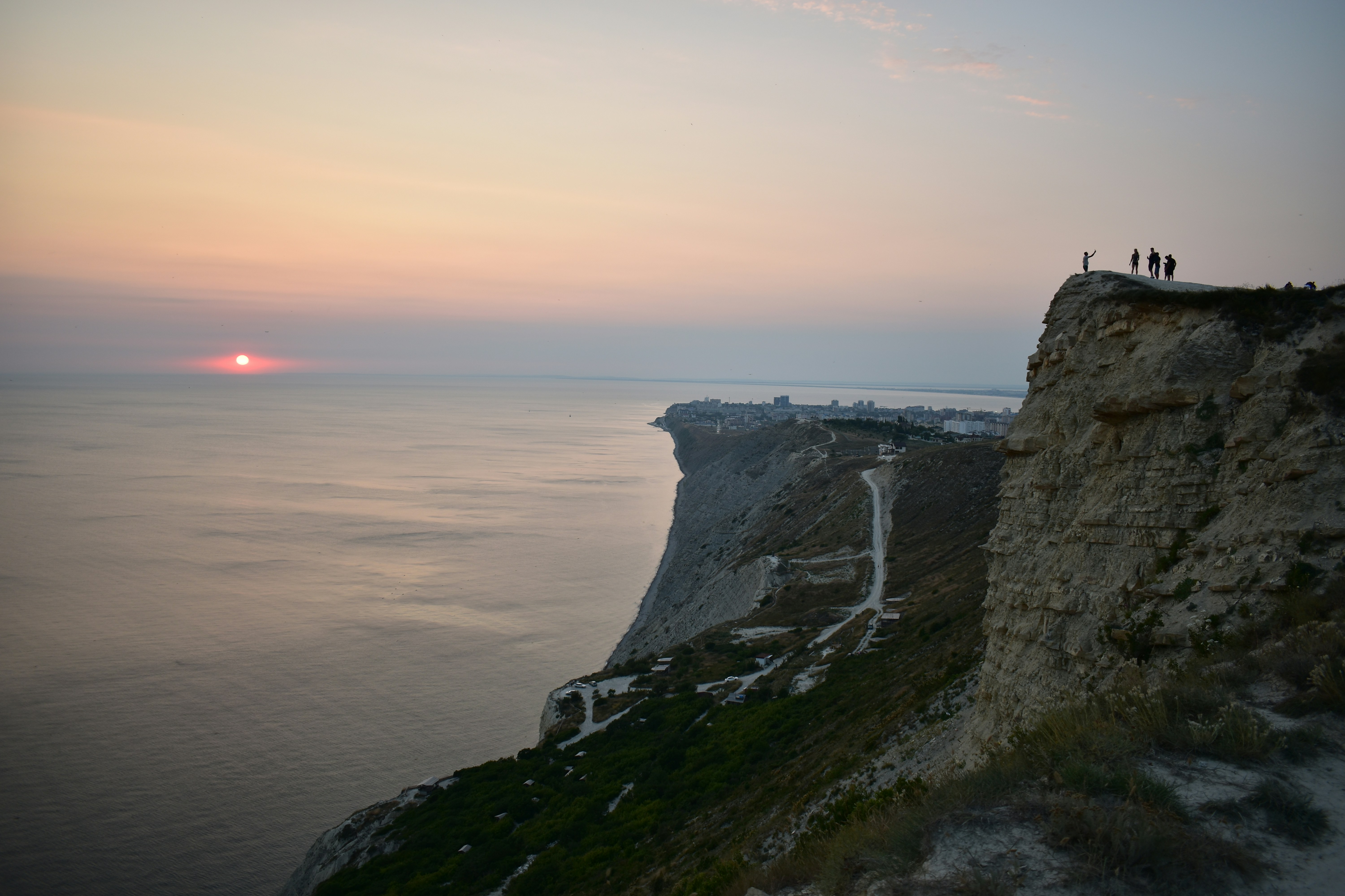 people standing on cliff