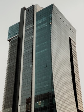 A sleek commercial office tower with glass facade.