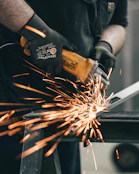 a man using a grinder on a piece of metal