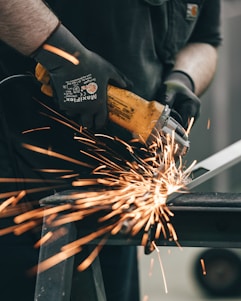 a man using a grinder on a piece of metal