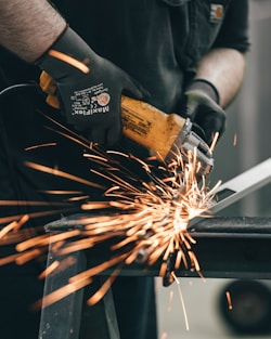 a man using a grinder on a piece of metal