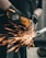 a man using a grinder on a piece of metal