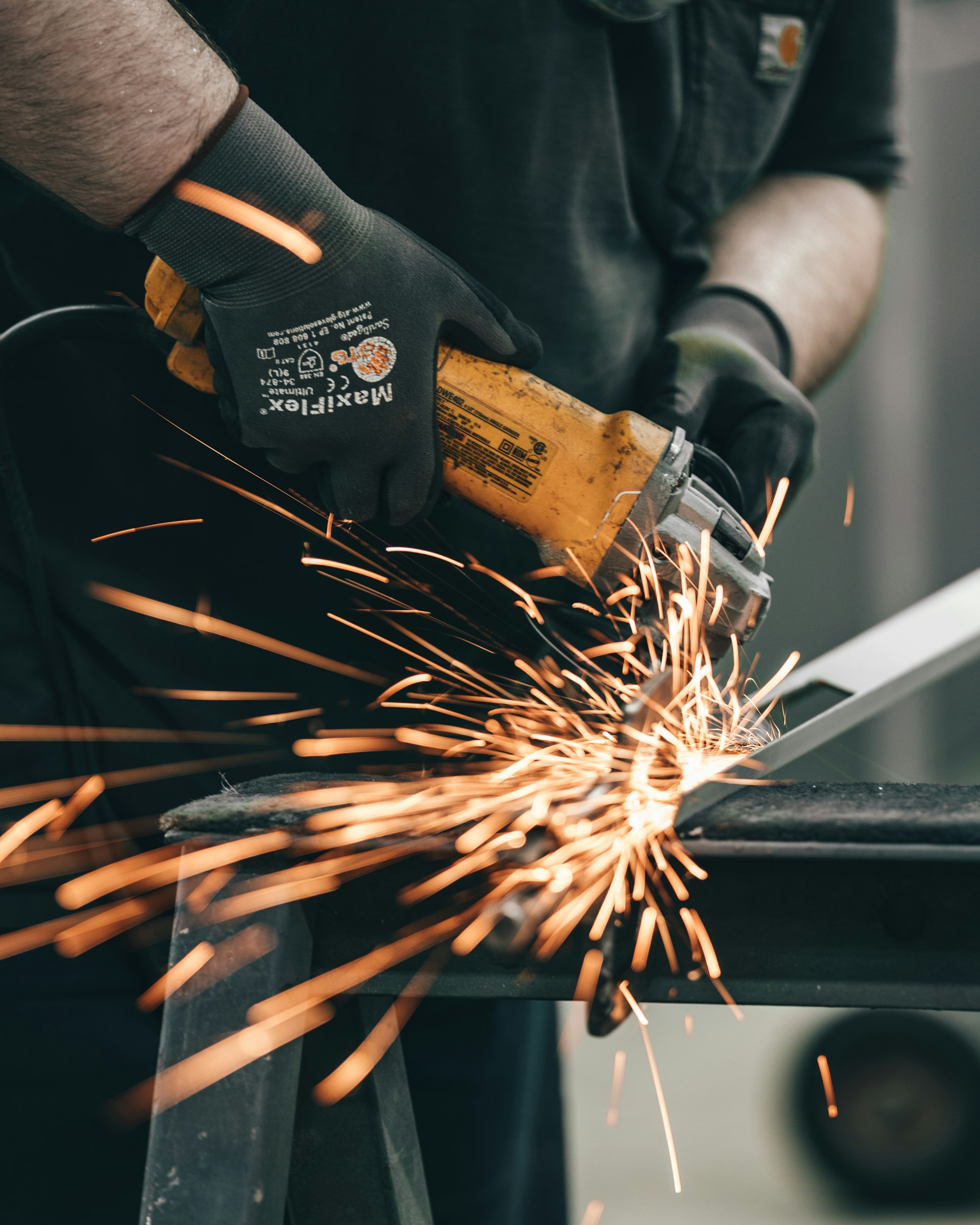 a man using a grinder on a piece of metal