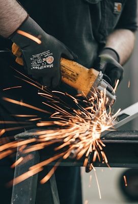 a man using a grinder on a piece of metal