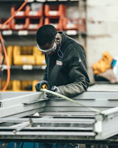 man wearing black jacket holding rod
