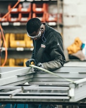man wearing black jacket holding rod