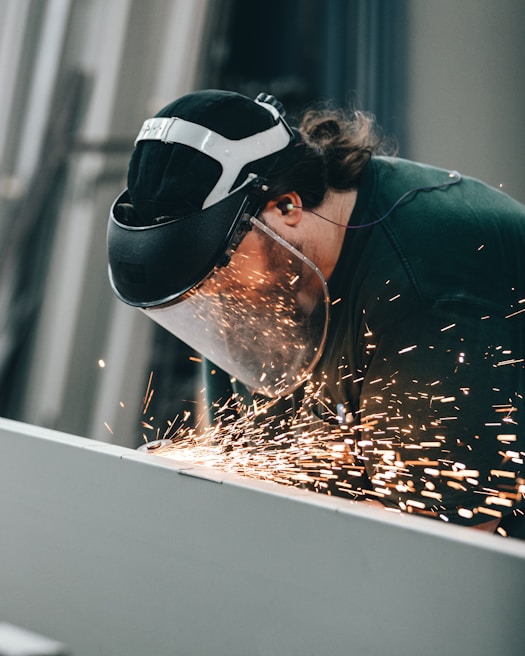 Close-up of a trainee using TIG welding equipment with protective gear