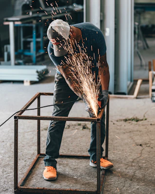 man welding frame
