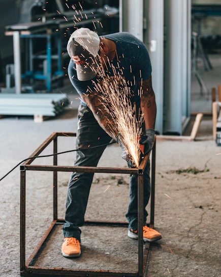 man welding frame