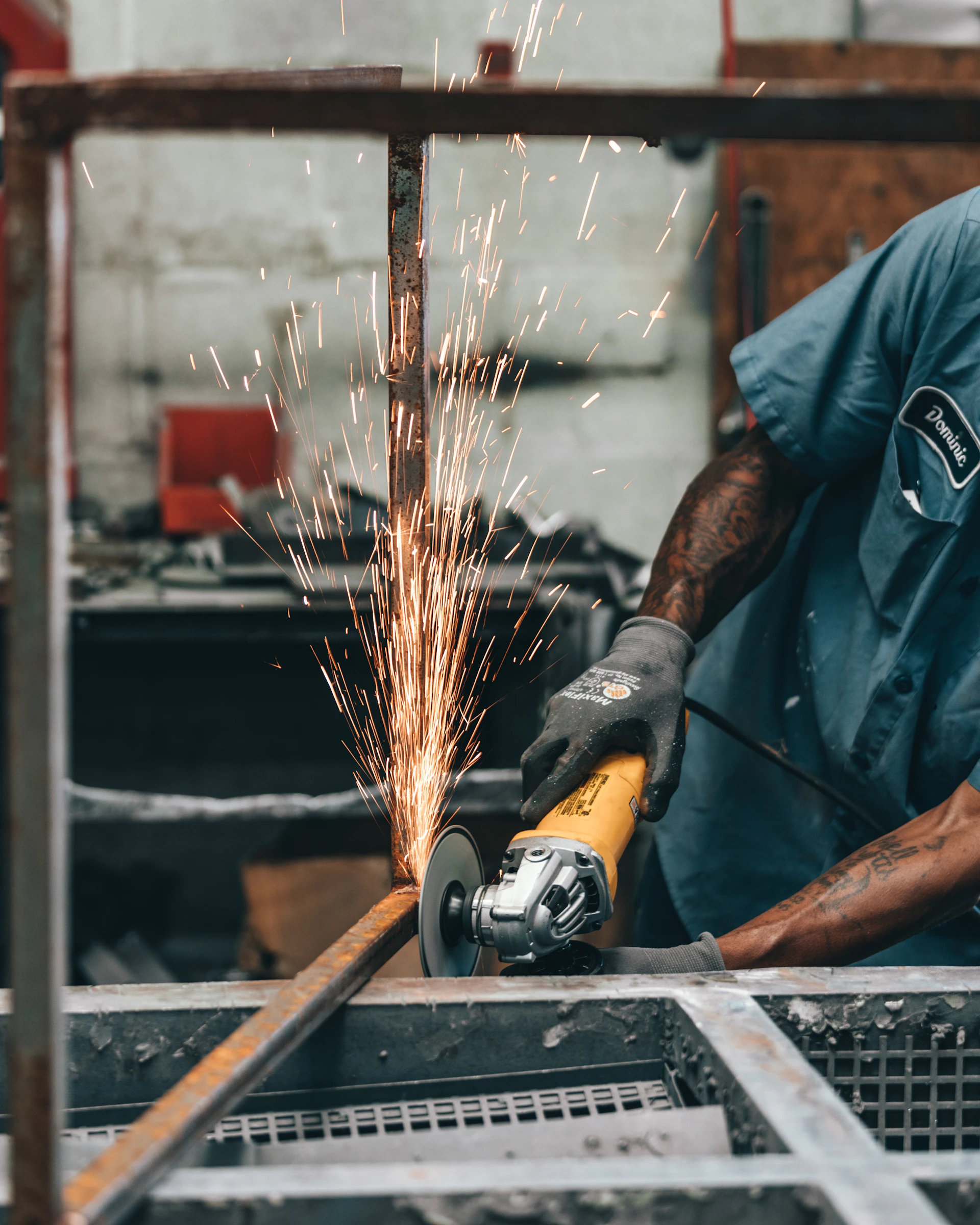 a man using a grinder on a piece of metal