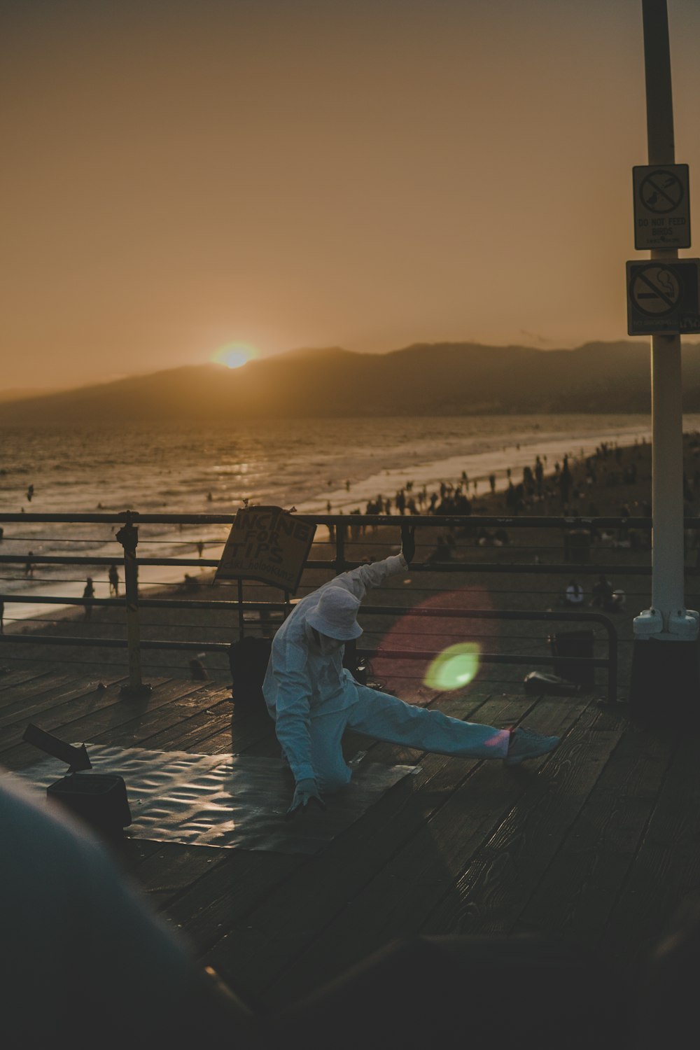 man in white jacket beside sea