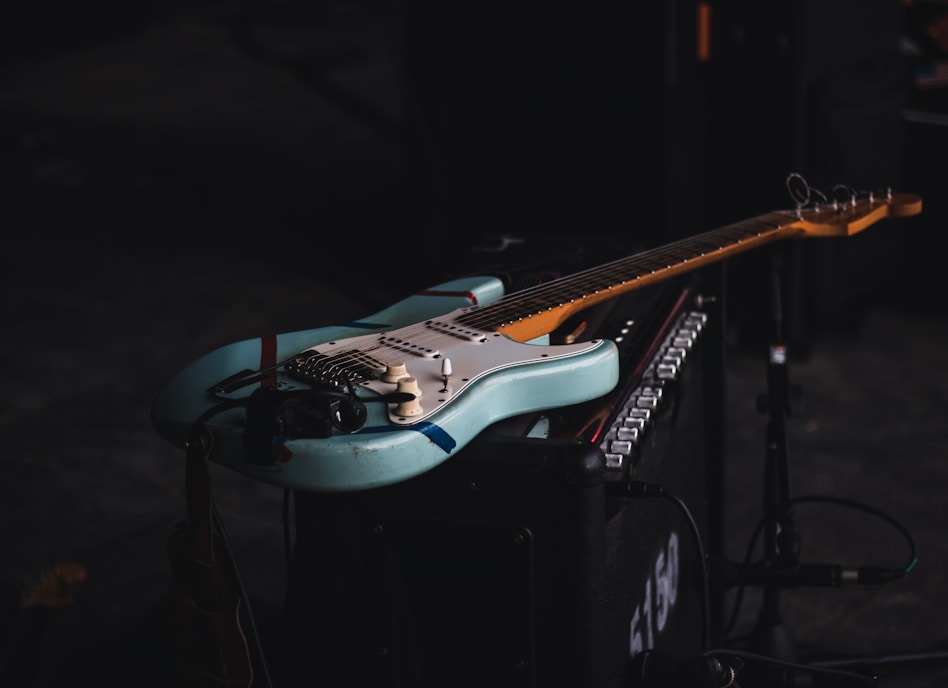 teal and brown electric guitar