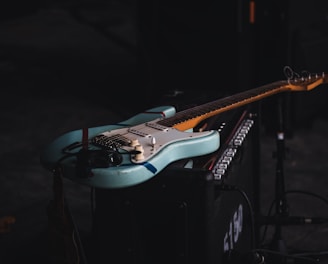 teal and brown electric guitar