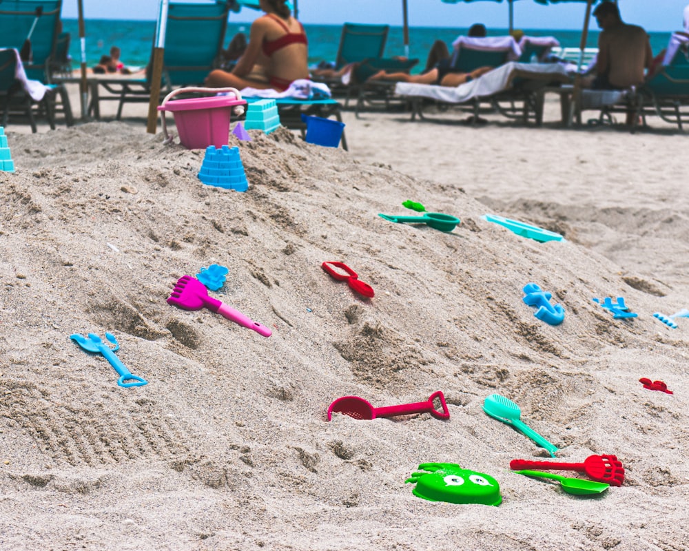 assorted-color toys on sand