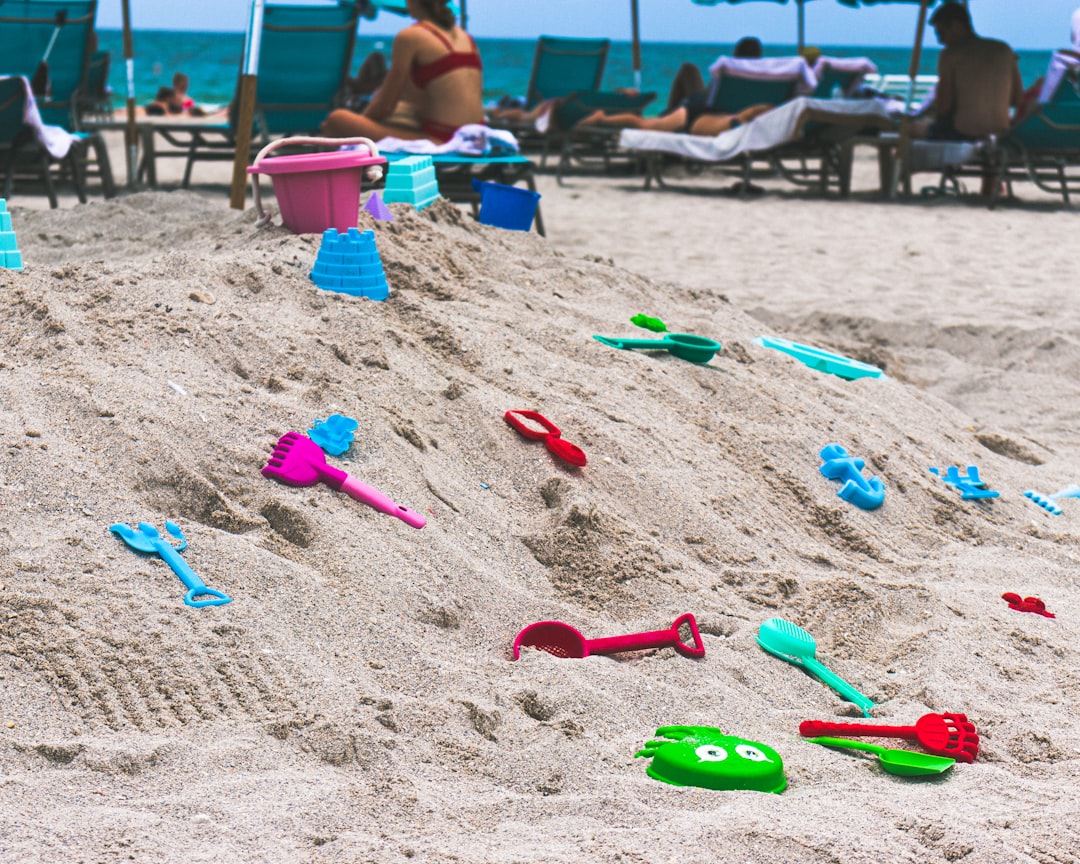 assorted-color toys on sand,