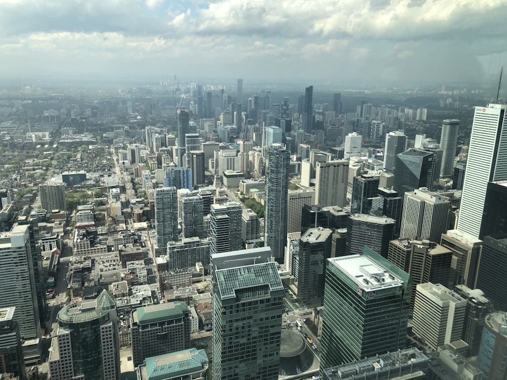 gray, green, and black high buildings at daytime