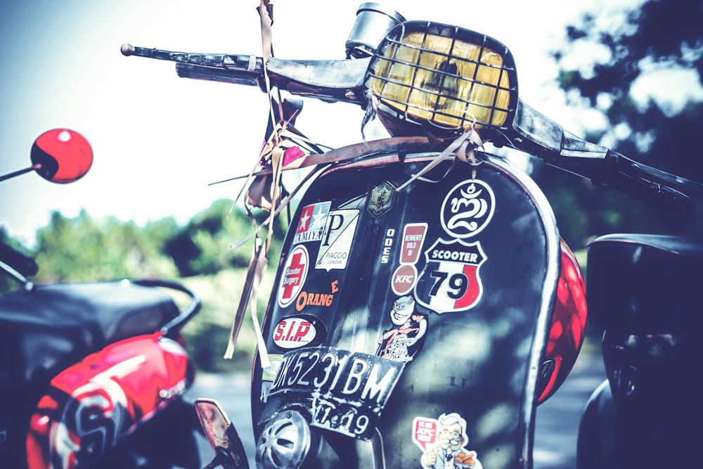 black motor scooter outdoor during daytime close-up photography