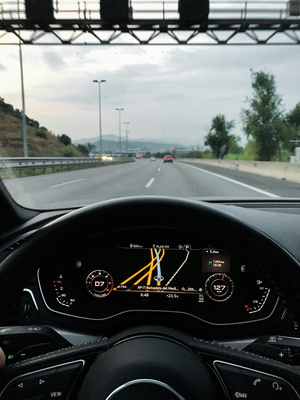 black vehicle in road during daytime