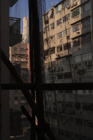 Wide shot showing a high-rise apartment with protective nets installed on all duct openings.