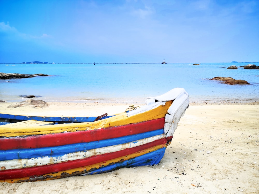 red, blue, and white boat