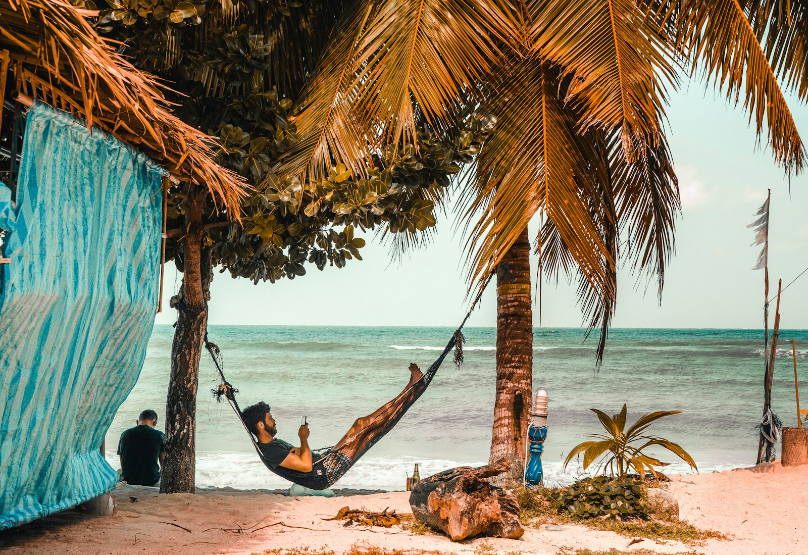 OLYMPUS M.25mm F1.2 sample photo. Man on hammock while photography