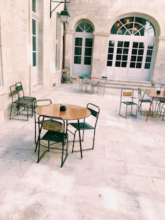 Open patio with warm Mediterranean light, shaded areas, and simple furniture.
