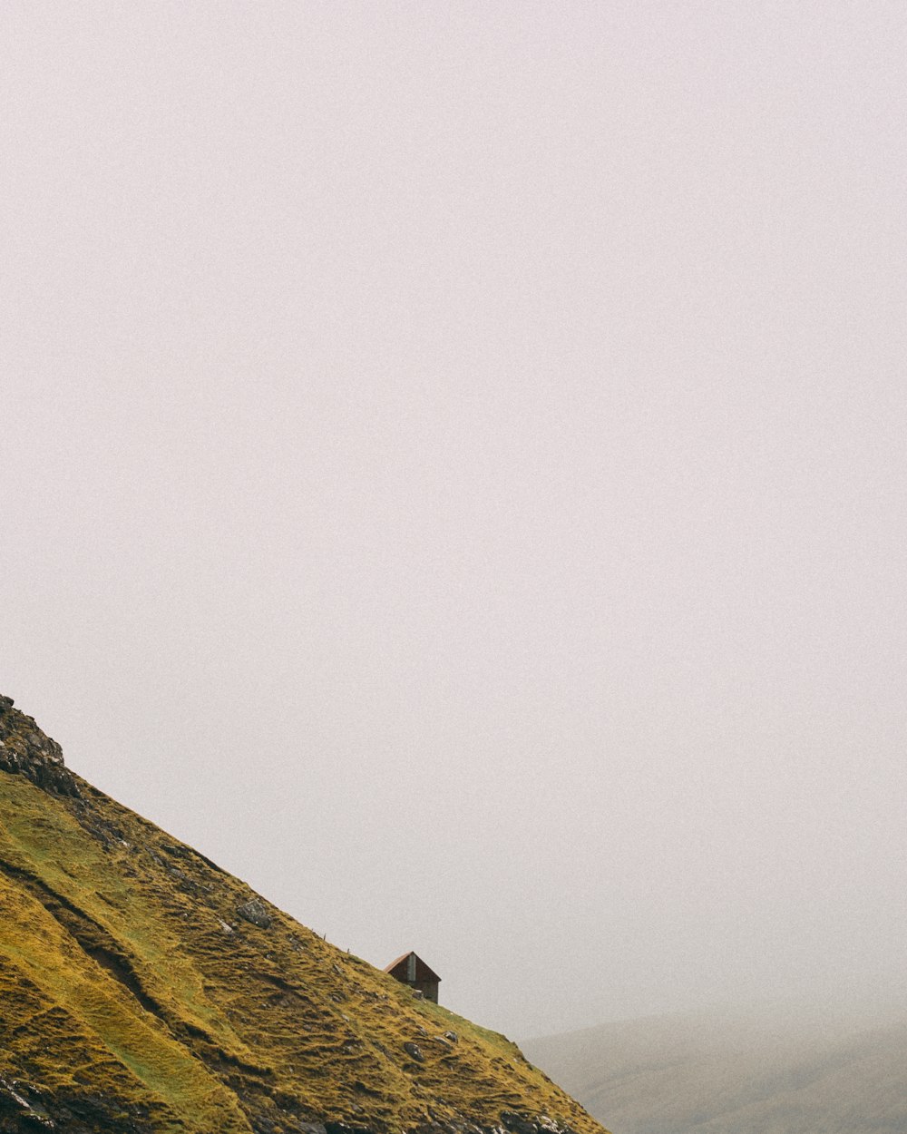 black and grey cottage in hill slope