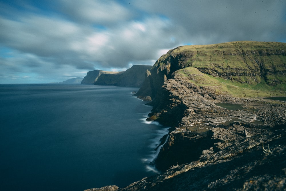 body of water near hill