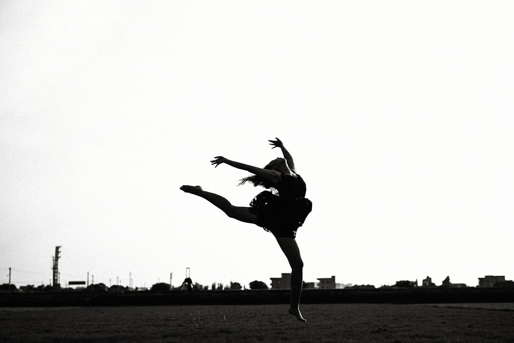 silhouette of jumping woman near outdoor
