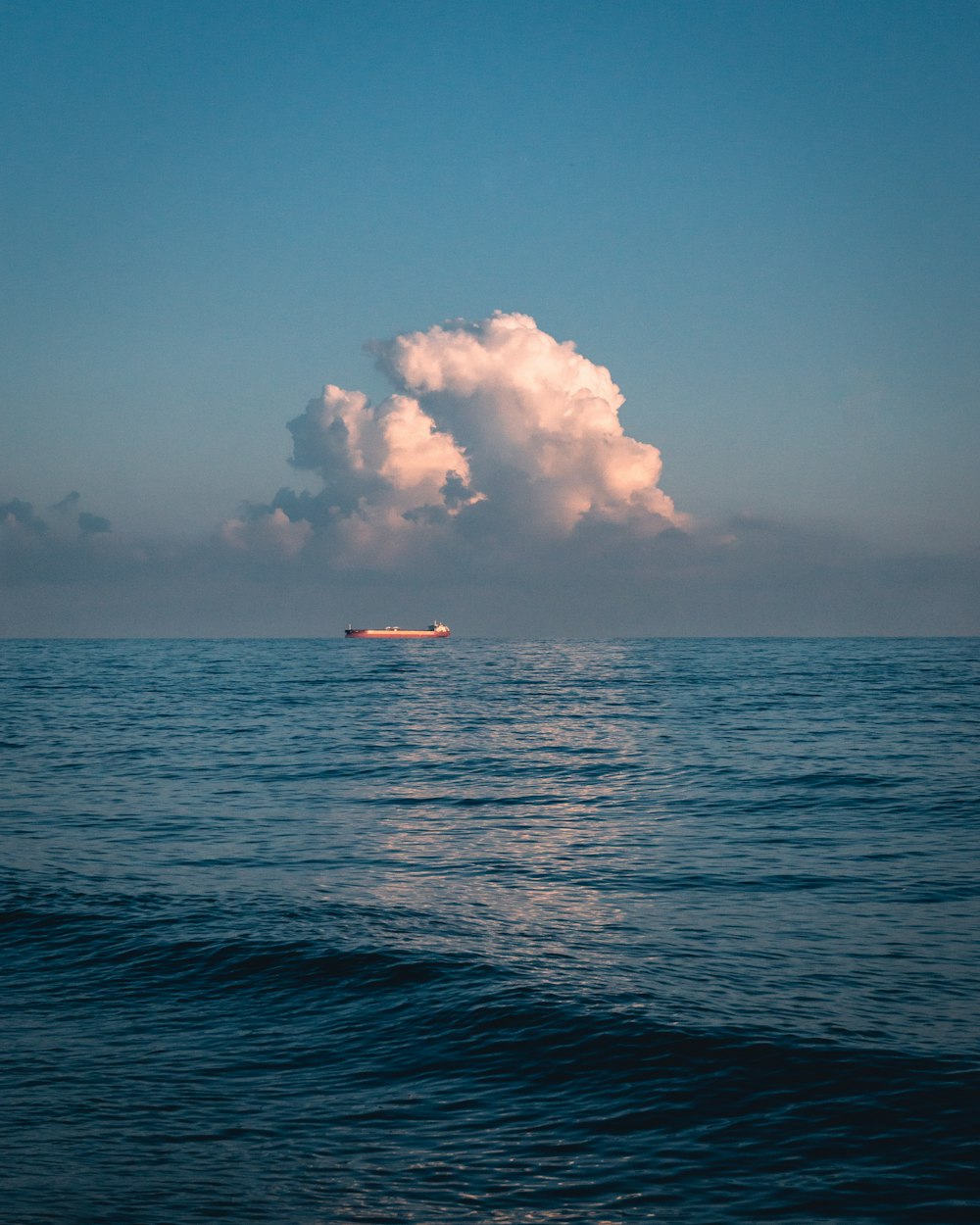 boat under white clouds