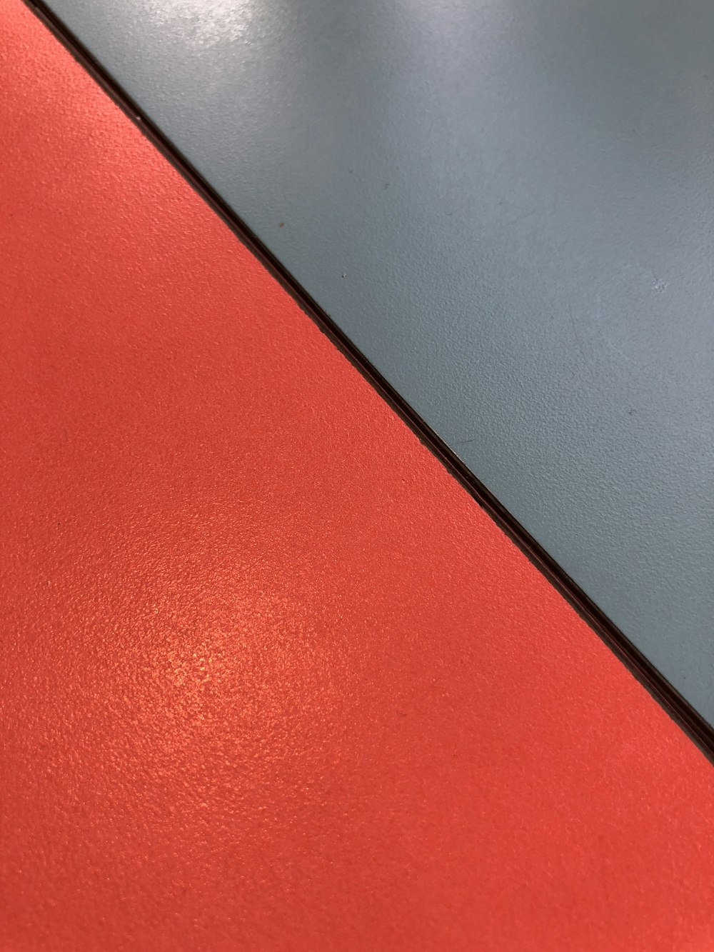 a close up of a red and grey surface