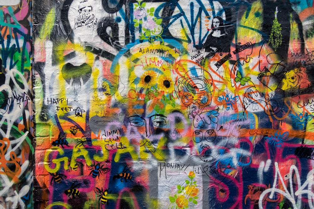 a wall covered in lots of colorful graffiti