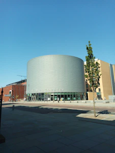 Modern office building exterior with Twola E-commerce Limited signage in Manchester, England.