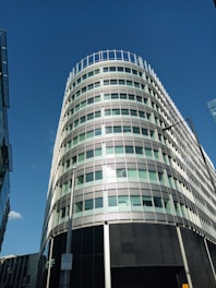 A modern condominium building with digital interface icons floating around it.