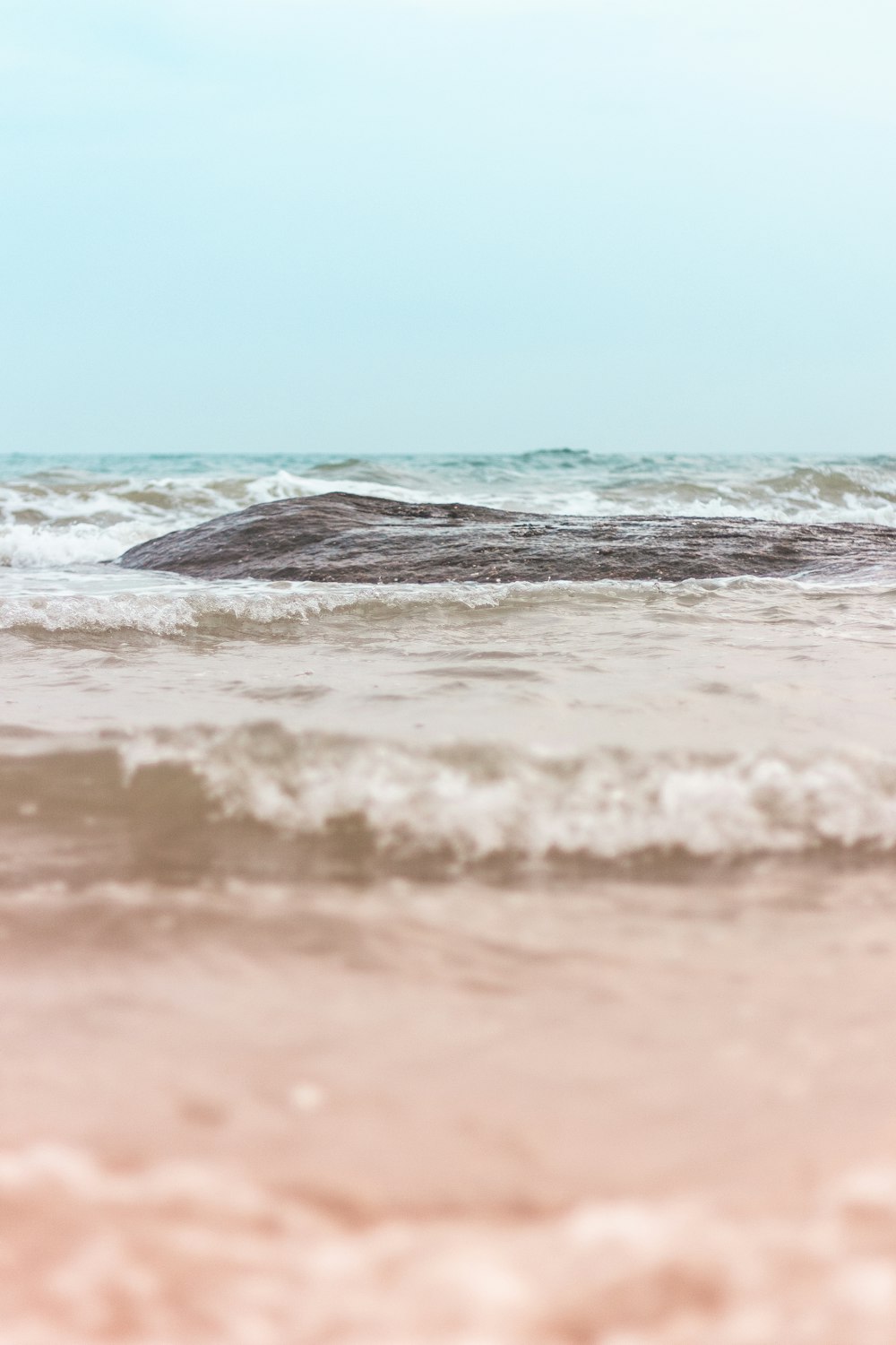 a large rock sticking out of the ocean