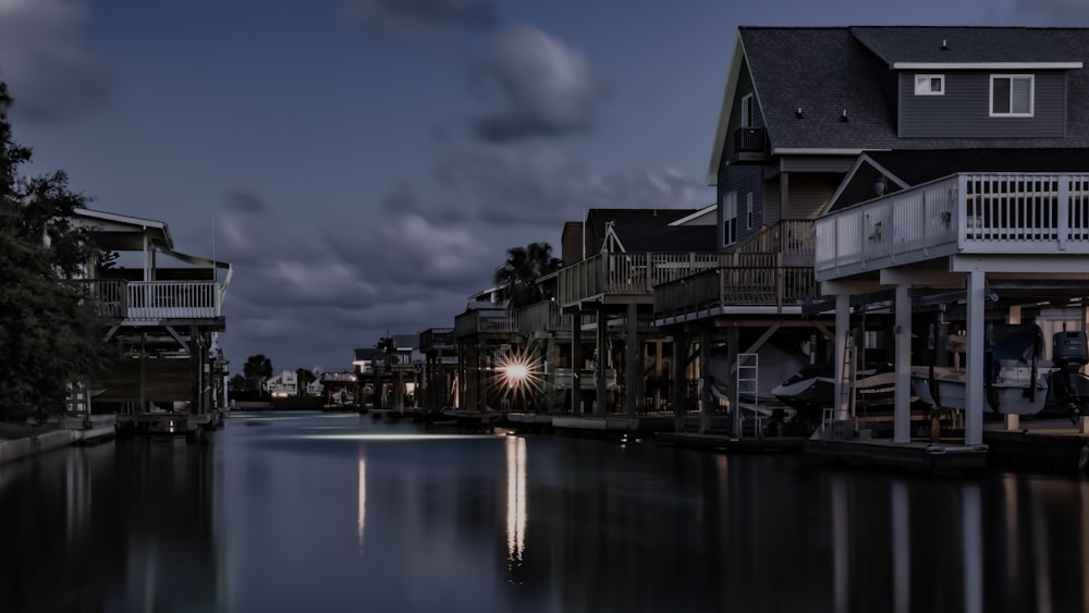 photography of river between buildings during nighttime