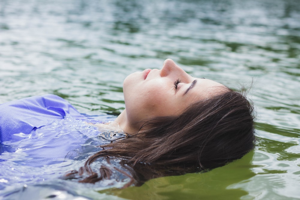 close-up photography of woman on body of water