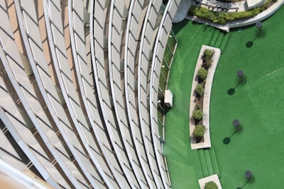 An aerial view of a sleek architectural site blending green landscaping with clean lines.