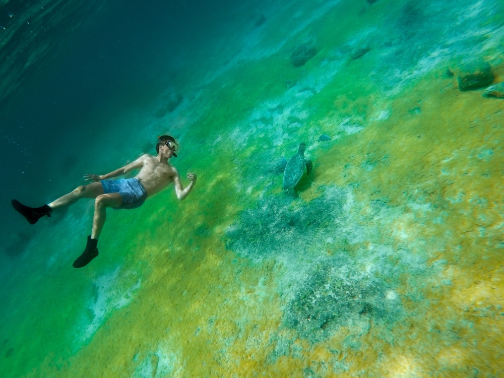 man swimming in sea