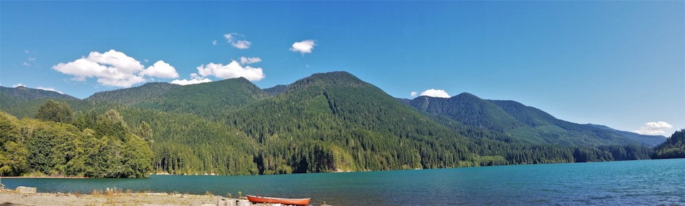 green mountain near body of water during daytime